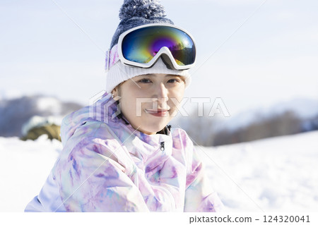 A woman enjoying snowboarding A woman enjoying snowboarding 124320041