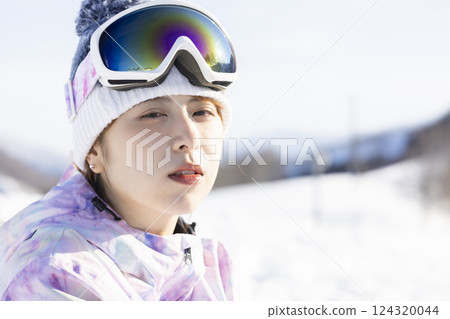A woman enjoying snowboarding A woman enjoying snowboarding 124320044