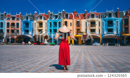female tourist traveler in Vietnamese hat Non La takes in sights on Vinpearl Island at VinWonders Amusement Park in Nha Trang at summer vacation in Asia. Travel and tourism in Vietnam female tourist traveler in Vietnamese hat Non La takes in sights on Vinpearl Island at VinWonders Amusement Park in Nha Trang at summer vacation in Asia. Travel and tourism in Vietnam 124320365