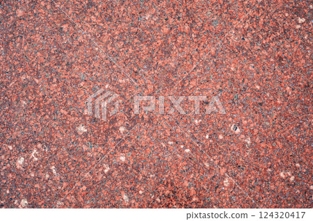 background with red granite tile texture. The texture of natural granite stone for decoration of facades and sidewalks background with red granite tile texture. The texture of natural granite stone for decoration of facades and sidewalks 124320417