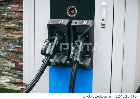 charging cable at modern energy electric charging station for charge electric automobiles close-up 124320436