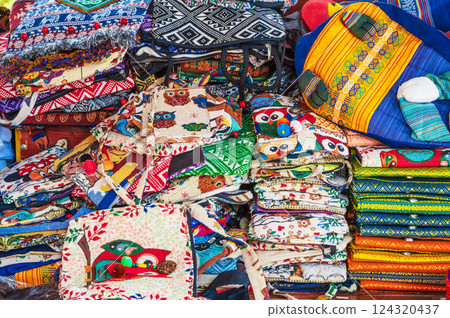 bright bags and traditional textiles on counter at the Asian market in Vietnam in Asia 124320437