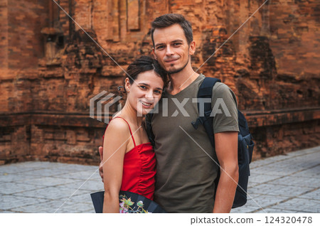 happy adult couple of tourists in love at the ancient famous landmark of Cham Towers of Po Nagar in Nha Trang in Vietnam in Asia happy adult couple of tourists in love at the ancient famous landmark of Cham Towers of Po Nagar in Nha Trang in Vietnam in Asia 124320478