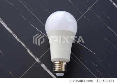 Image of an electricity bill with a light bulb on a black background Image of an electricity bill with a light bulb on a black background 124320584