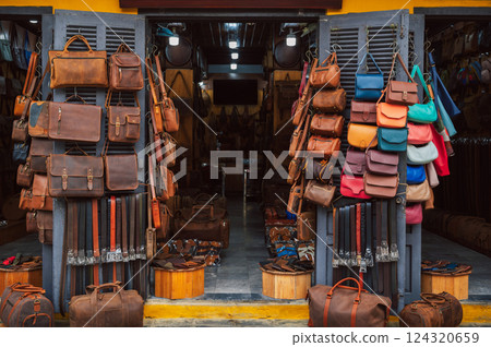 handmade leather bags, belts and accessories on counter in a shop at street market in Hoi An in Vietnam in Asia handmade leather bags, belts and accessories on counter in a shop at street market in Hoi An in Vietnam in Asia 124320659