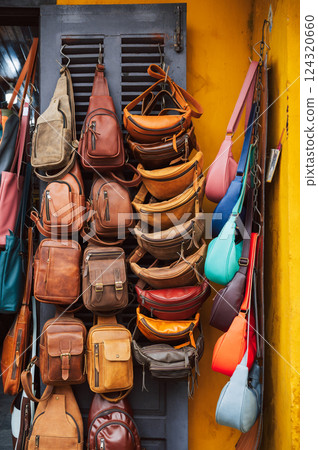 handmade leather bags, belts and accessories on counter in a shop at street market in Vietnam in Asia handmade leather bags, belts and accessories on counter in a shop at street market in Vietnam in Asia 124320660