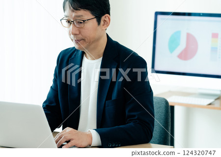 A man who operates a personal computer 124320747