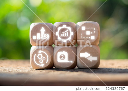 Wooden blocks with productivity symbols illustrating growth, efficiency, and workflow against a natural backdrop. Wooden blocks with productivity symbols illustrating growth, efficiency, and workflow against a natural backdrop. 124320767