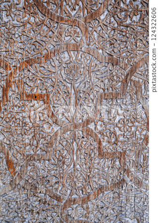 traditional Uzbek retro carved pattern on vintage old wooden door in Tashkent in Uzbekistan close-up traditional Uzbek retro carved pattern on vintage old wooden door in Tashkent in Uzbekistan close-up 124322606