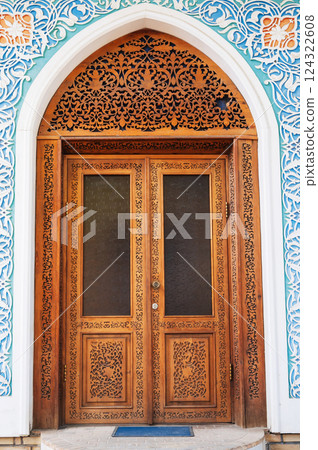 old vintage wooden door with traditional Uzbek carved pattern in Uzbekistan 124322608