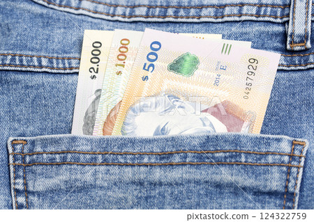 Uruguayan peso in the pocket of blue jeans Uruguayan peso in the pocket of blue jeans 124322759