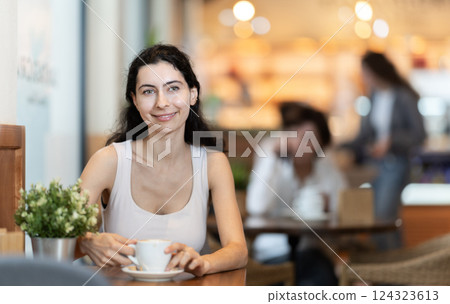 Woman enjoying a cup of coffee in the afternoon Woman enjoying a cup of coffee in the afternoon 124323613