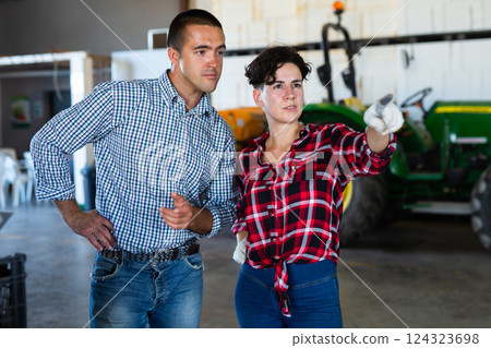 Farmers discussing work in agricultural facility 124323698