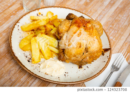 Tasty roasted chicken thigh served with boiled potatoes 124323708
