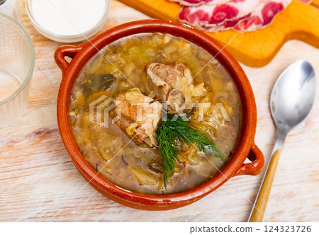 Thick cabbage soup shchi with pork cooked in mushroom broth Thick cabbage soup shchi with pork cooked in mushroom broth 124323726