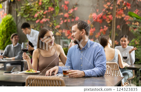 Man and woman spending time together at an open air restaurant 124323835