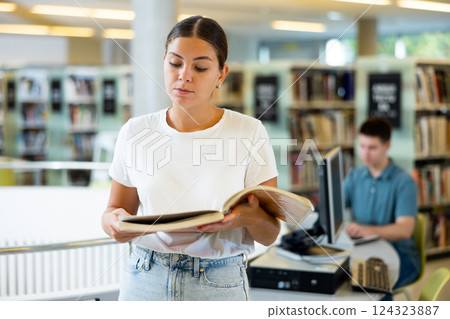 Intelligent Caucasian girl hold academic books 124323887