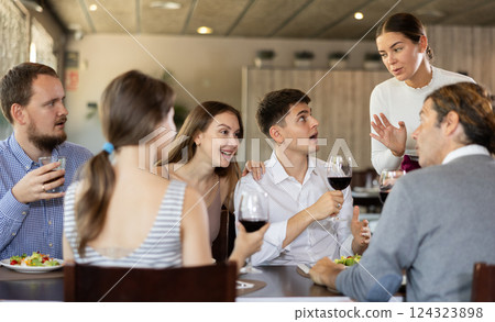 Female waitress taking order from group of friends in restaurant 124323898