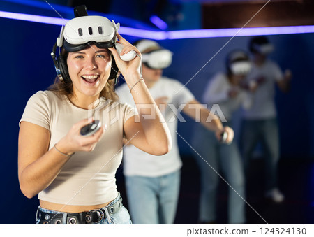 Stunned by exciting game, girl lowered helmet and took break from game. 124324130