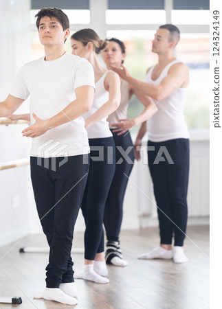 Young ballet dancer practicing at group class with choreographer 124324149