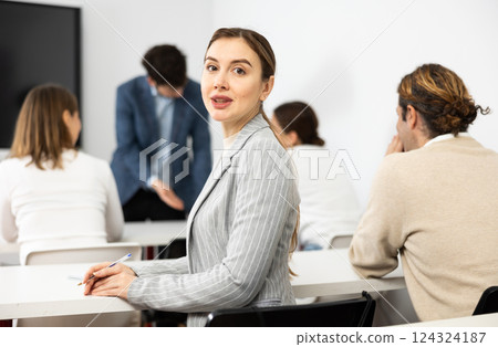 Young smiling woman attending lecture in university 124324187