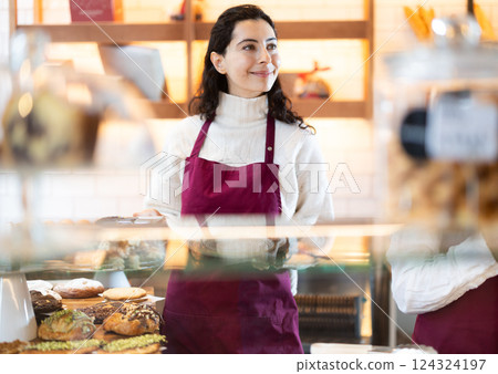 Woman folding fresh pastries Woman folding fresh pastries 124324197