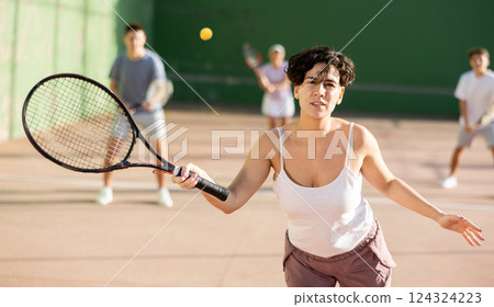 Woman playing frontenis on outdoor pelota court Woman playing frontenis on outdoor pelota court 124324223