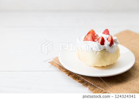 Crepe cake topped with fresh cream and strawberries. 124324341