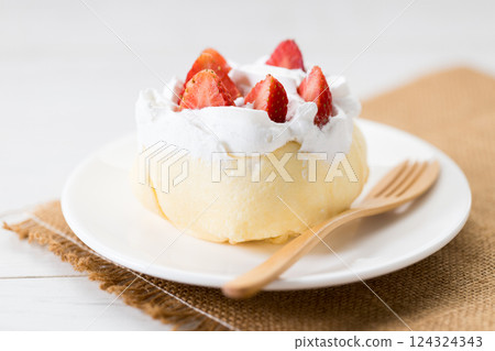 Crepe cake topped with fresh cream and strawberries. 124324343