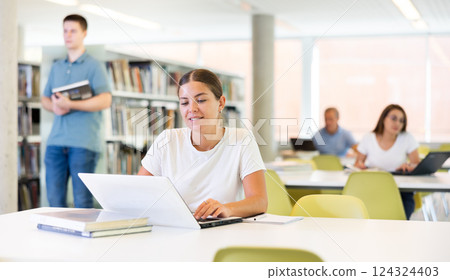 Smart female American student preparing for the exam Smart female American student preparing for the exam 124324403