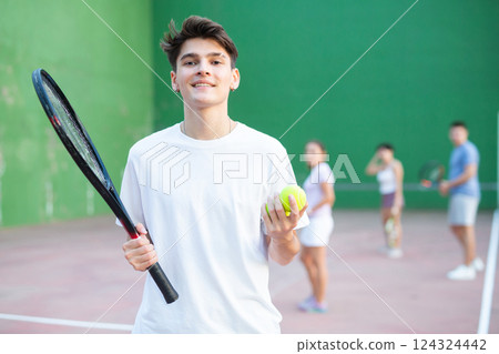 Portrait of positive young man frontenis player 124324442