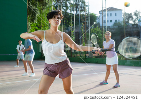 Woman playing frontenis on outdoor pelota court 124324451