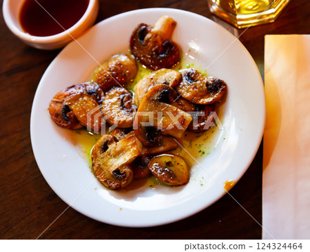 Close-up of tasty cooked fried champignon mushrooms at plate 124324464