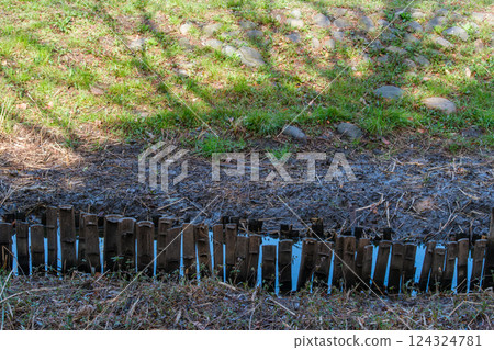 Stream and bamboo fence 124324781