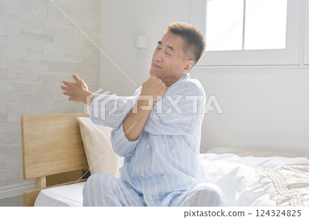 Middle-aged man stretching arms waking up 124324825