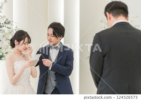 Bride/bride reading a letter to parents at a wedding (father/bride's letter/crying) 124326573