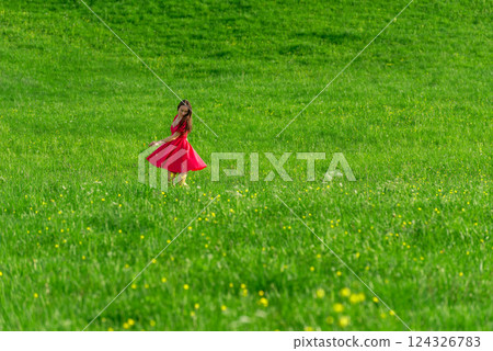 Young woman enjoying nature at sunset on a green grass meadow Young woman enjoying nature at sunset on a green grass meadow 124326783