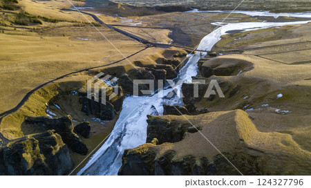 Aerial landscape view of Fjarrgljfur or Fjadrargljufur Canyon with Fjadrar river flow on Iceland. Taken by drone. Nature, travel, winter background, or wallpaper Aerial landscape view of Fjarrgljfur or Fjadrargljufur Canyon with Fjadrar river flow on Iceland. Taken by drone. Nature, travel, winter background, or wallpaper 124327796
