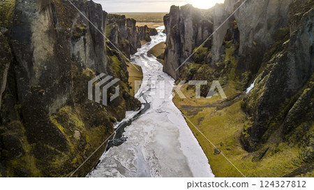 Aerial landscape view of Fjarrgljfur or Fjadrargljufur Canyon with Fjadrar river flow on Iceland. Taken by drone. Nature, travel, winter background, or wallpaper 124327812