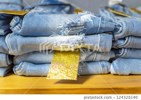 Close up of blue jeans on others with copy space; Various jeans on others with space for text 124328140