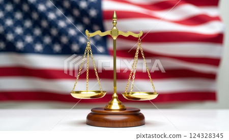 Gold Justice scales in front of American flag, on wooden background 124328345