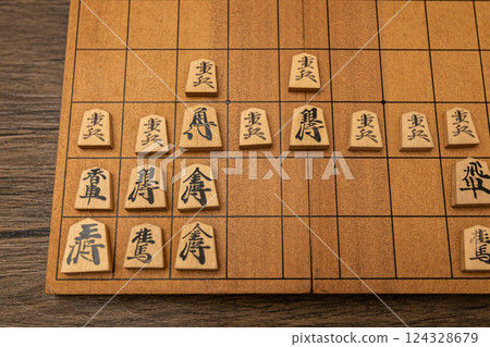 Shogi pieces are lined up on a shogi board. They are defending with the Anaguma strategy. 124328679