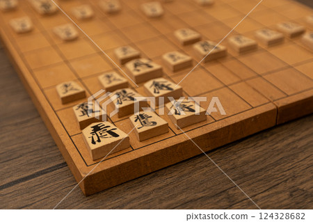 Shogi pieces are lined up on a shogi board. They are defending with the Anaguma strategy. 124328682