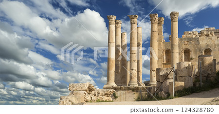 Temple of Zeus, Jordanian city of Jerash  (Gerasa of Antiquity), capital and largest city of Jerash Governorate, Jordan. Against the background of a beautiful sky with clouds 124328780