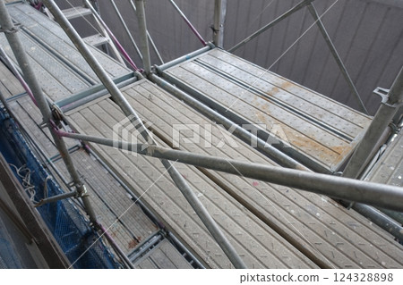 Scaffolding for repair work on the exterior walls of a high-rise apartment building 124328898