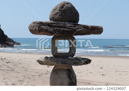 A calm afternoon sea seen through the stone tower at Hakuto Beach A calm afternoon sea seen through the stone tower at Hakuto Beach 124329007