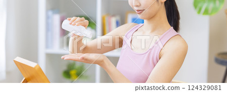 美容圖片：一位女士將美容精華液滴在手上 124329081