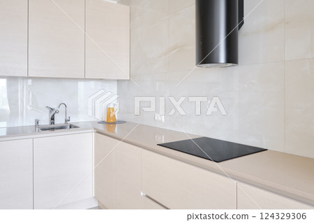 Modern kitchen with sleek design and minimalistic features in bright natural light 124329306