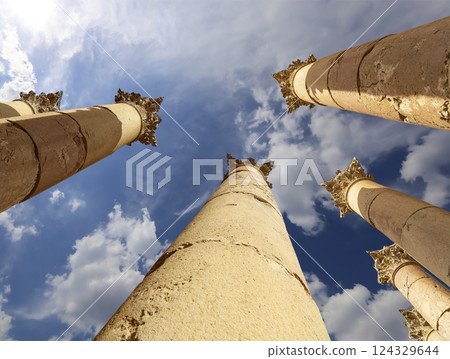 Roman Columns in the Jordanian city of Jerash (Gerasa of Antiquity), capital and largest city of Jerash Governorate, Jordan. Against the background of a beautiful sky with clouds 124329644