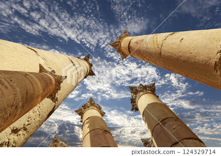 Roman Columns in the Jordanian city of Jerash (Gerasa of Antiquity), capital and largest city of Jerash Governorate, Jordan. Against the background of a beautiful sky with clouds Roman Columns in the Jordanian city of Jerash (Gerasa of Antiquity), capital and largest city of Jerash Governorate, Jordan. Against the background of a beautiful sky with clouds 124329714